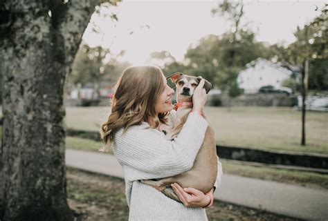 woman carrying dog